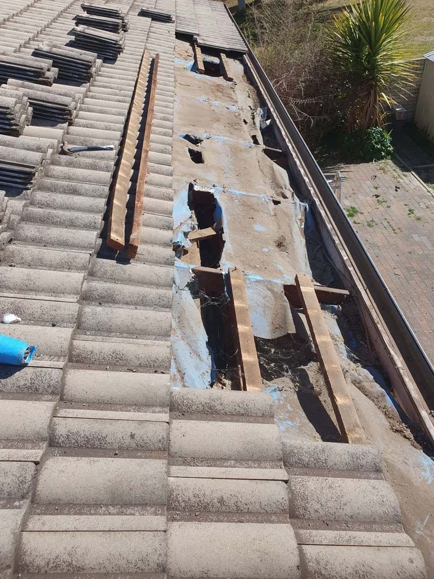 House With Roof Restoration Under Construction — ACT Roofing in Ngunnawal, ACT