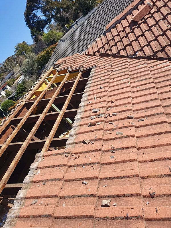 A Broken Roof Is Being Repaired — ACT Roofing in Ngunnawal, ACT