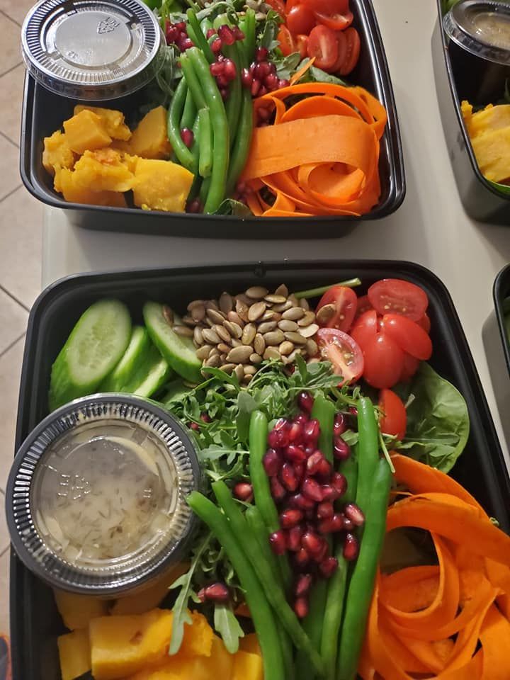 a salad with olives tomatoes and onions on a white plate