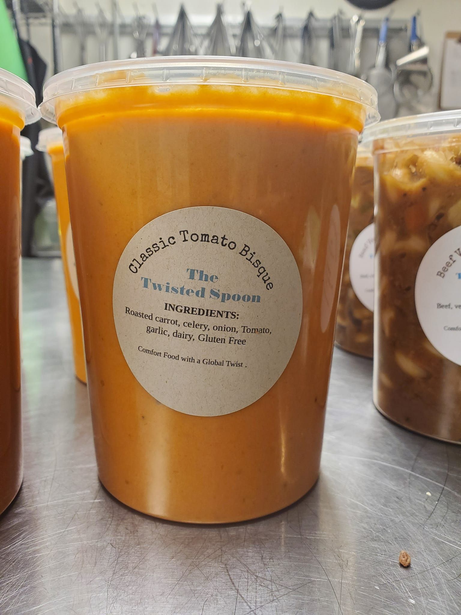 a plastic container of classic tomato bisque soup