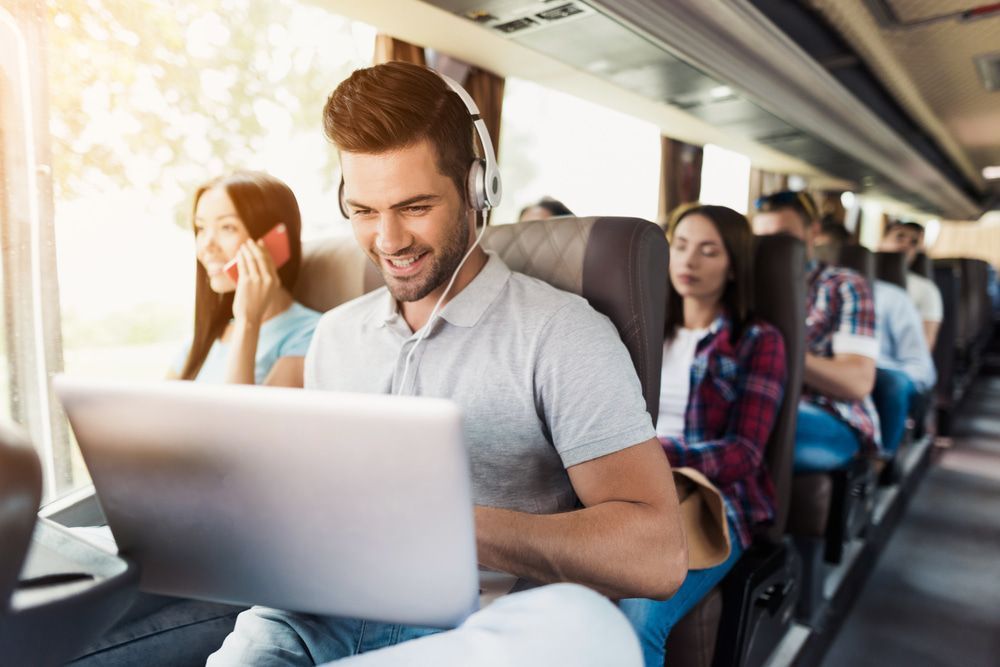 Passenger Using a Laptop on a Train — J & B Bus and Coach Pty Ltd In Tweed Heads, NSW