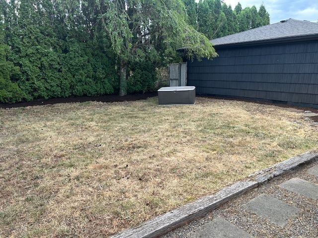 There is a hot tub in the backyard of a house.
