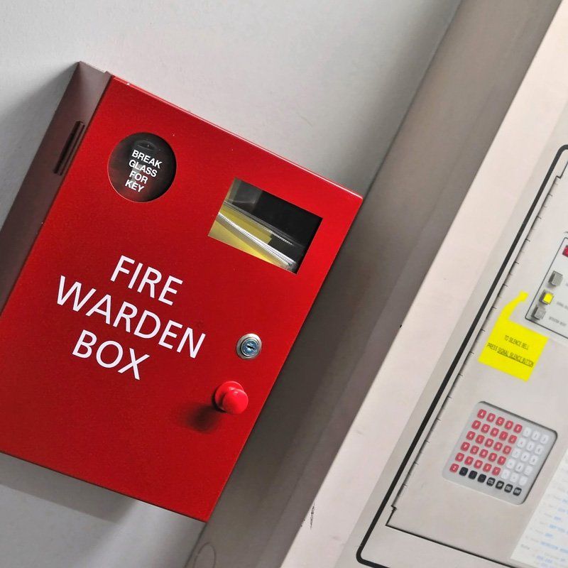 Fire exit sign lightbox in the airport terminal emergency exit way. Green emergency exit sign direction in case of emergency signage.