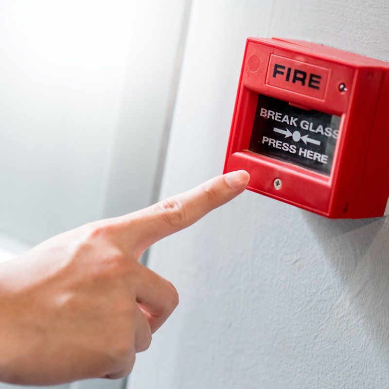Old red box fire alarm on cement wall