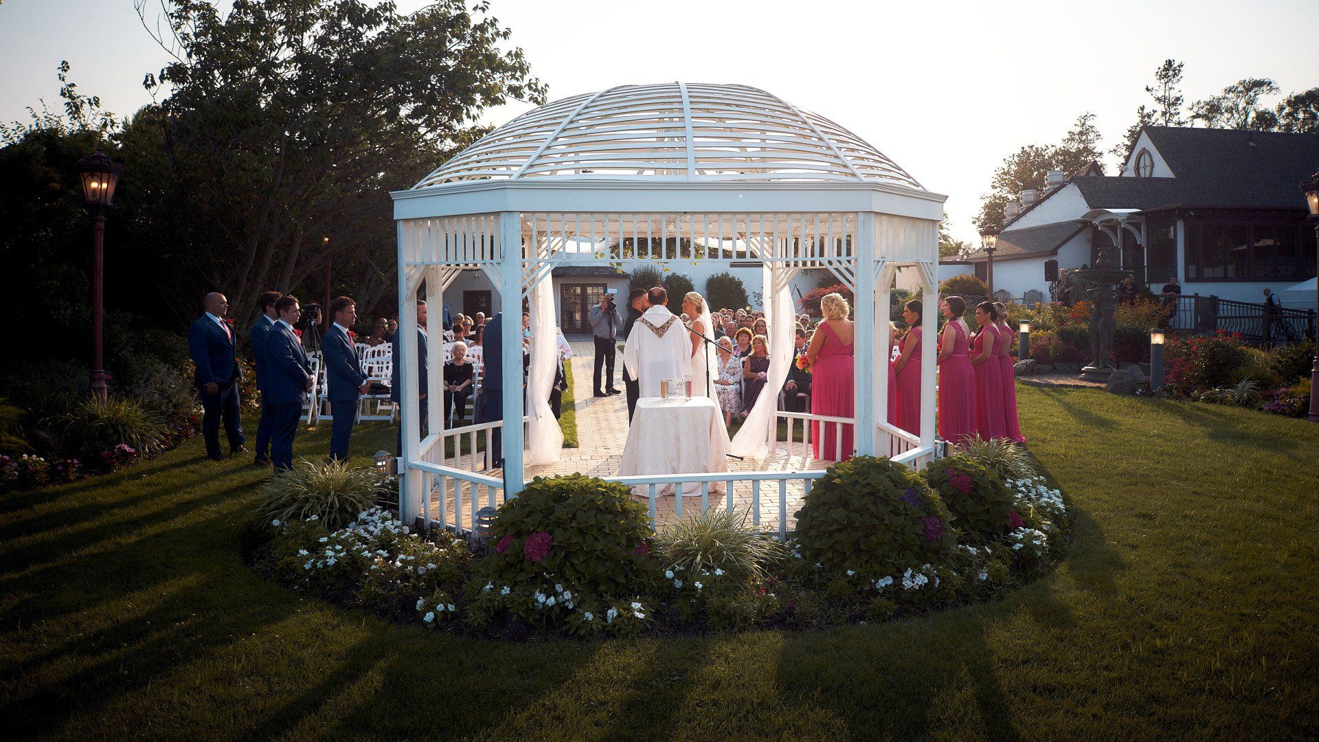 A bride and groom are getting married in a gazebo