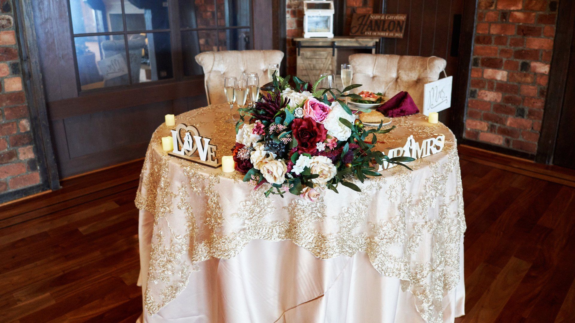 A table with flowers and candles on it in a room.