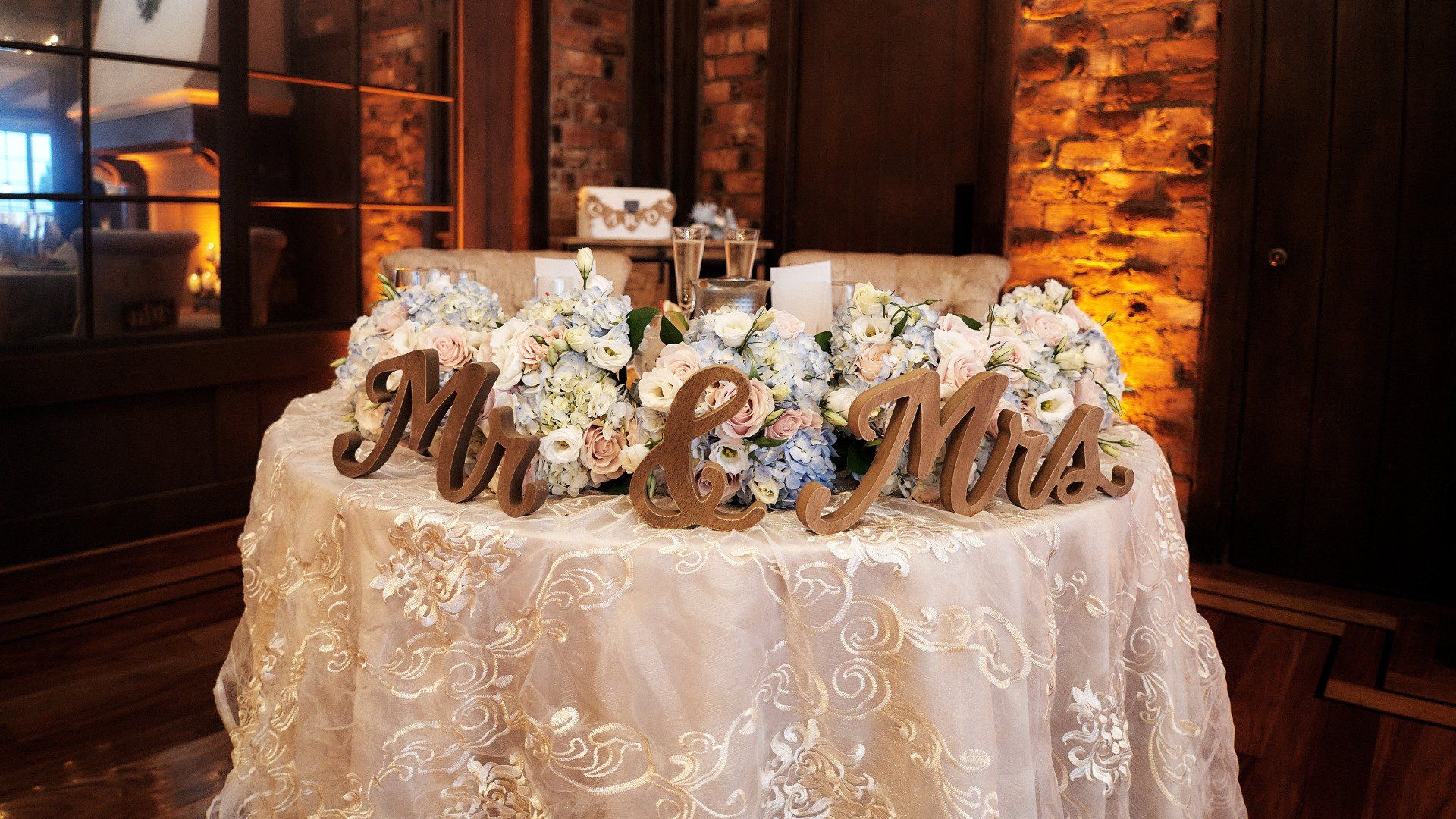 A table with flowers and wooden signs that say mr. and mrs.