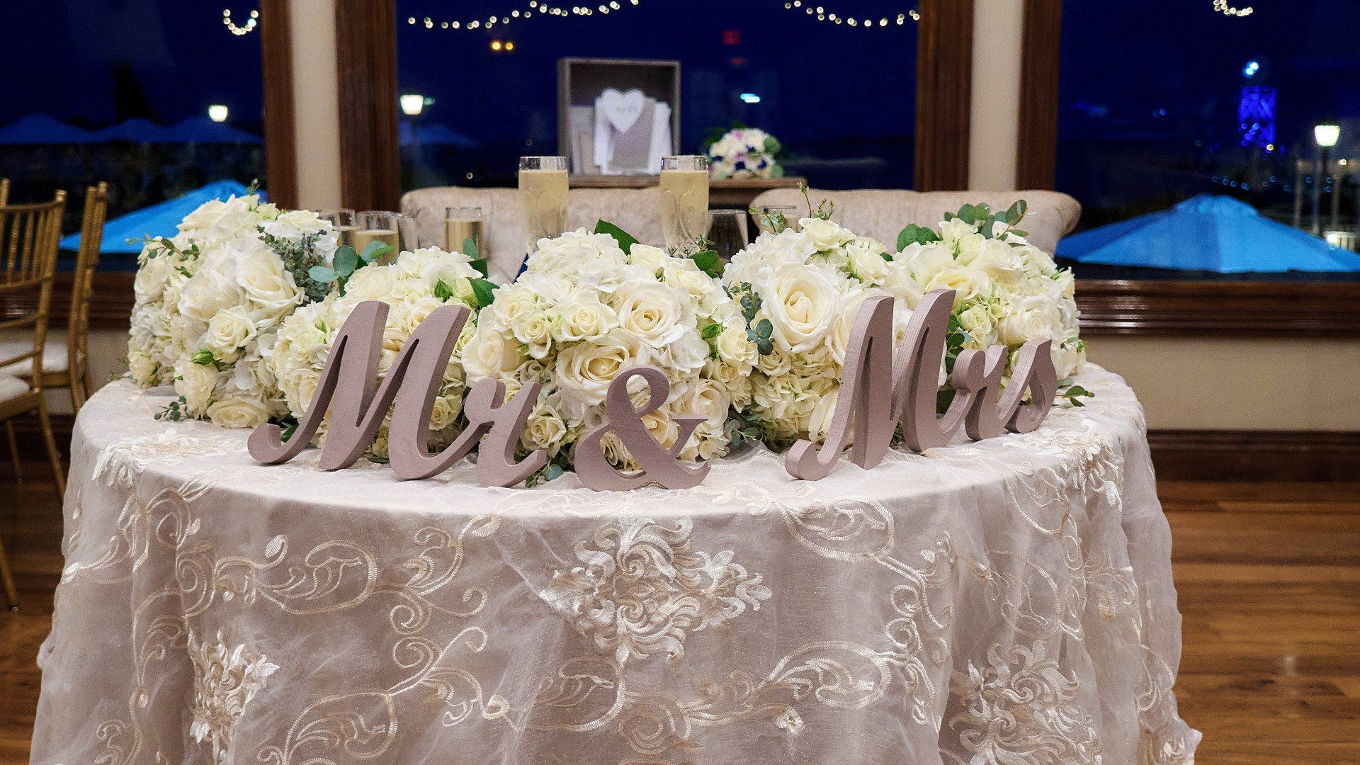 A table with flowers and a sign that says mr. and mrs.