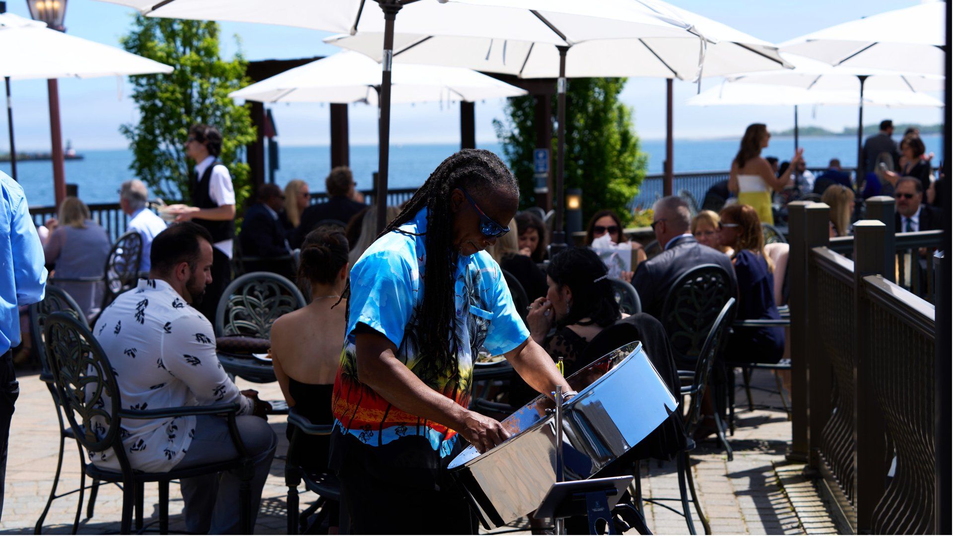 A man is playing a drum in front of a crowd of people