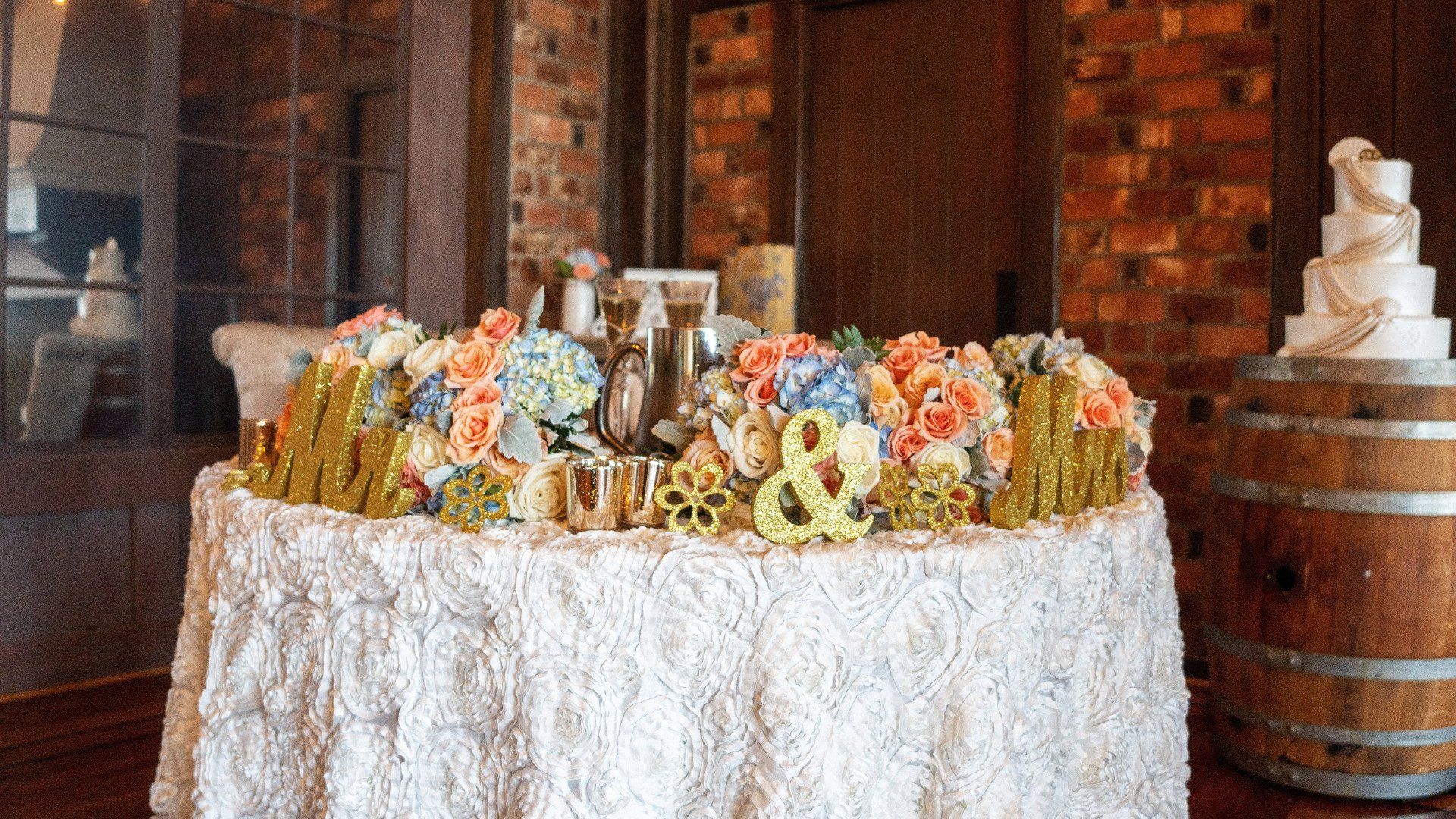 A table with a white table cloth and flowers on it.