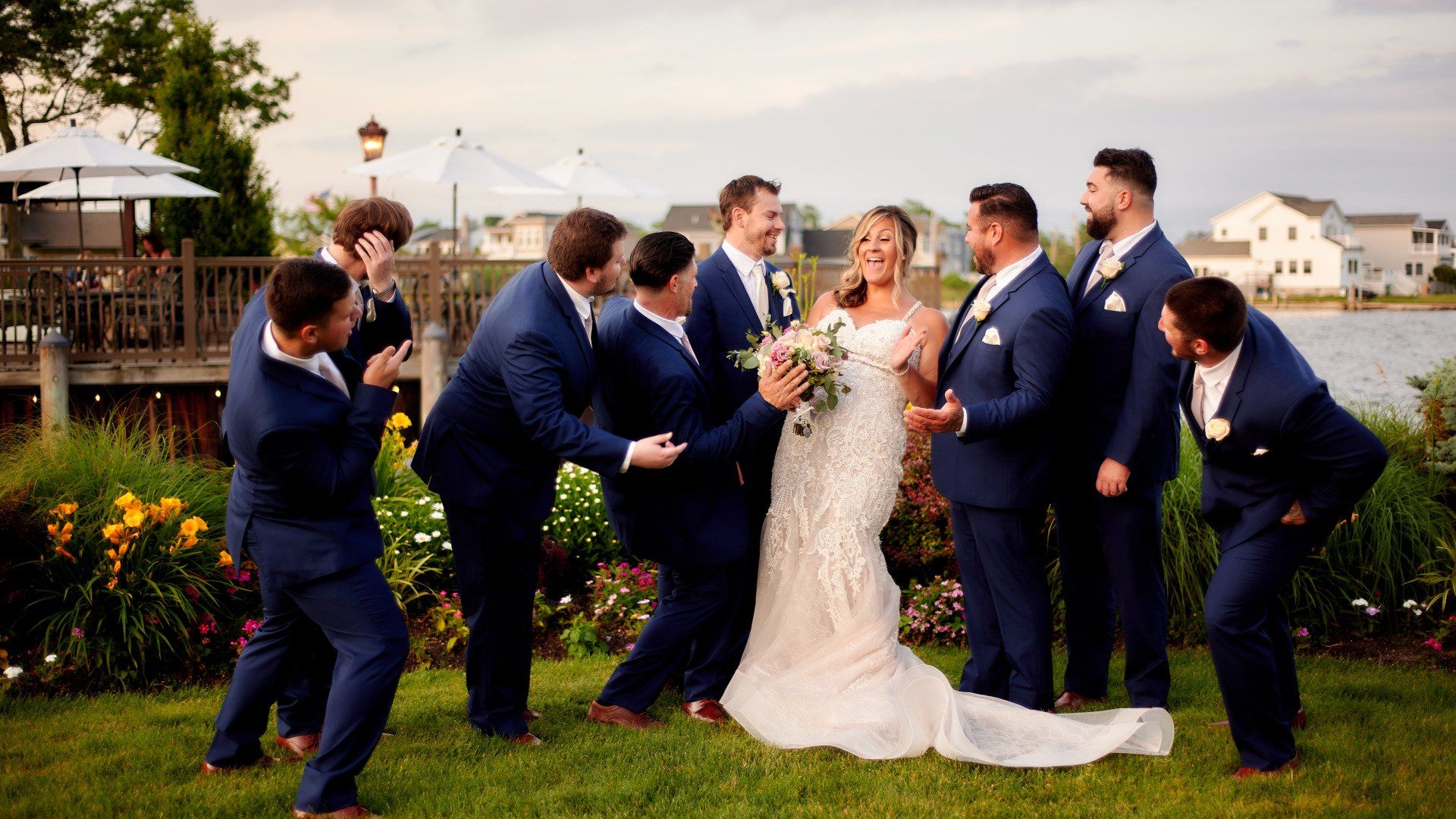 A bride and groom are posing for a picture with their wedding party.