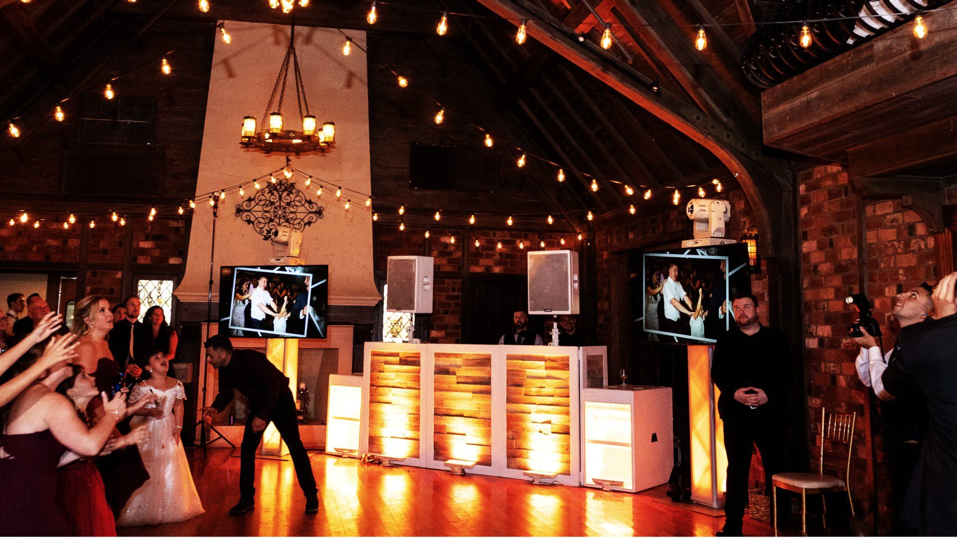 A bride and groom are dancing at a wedding reception