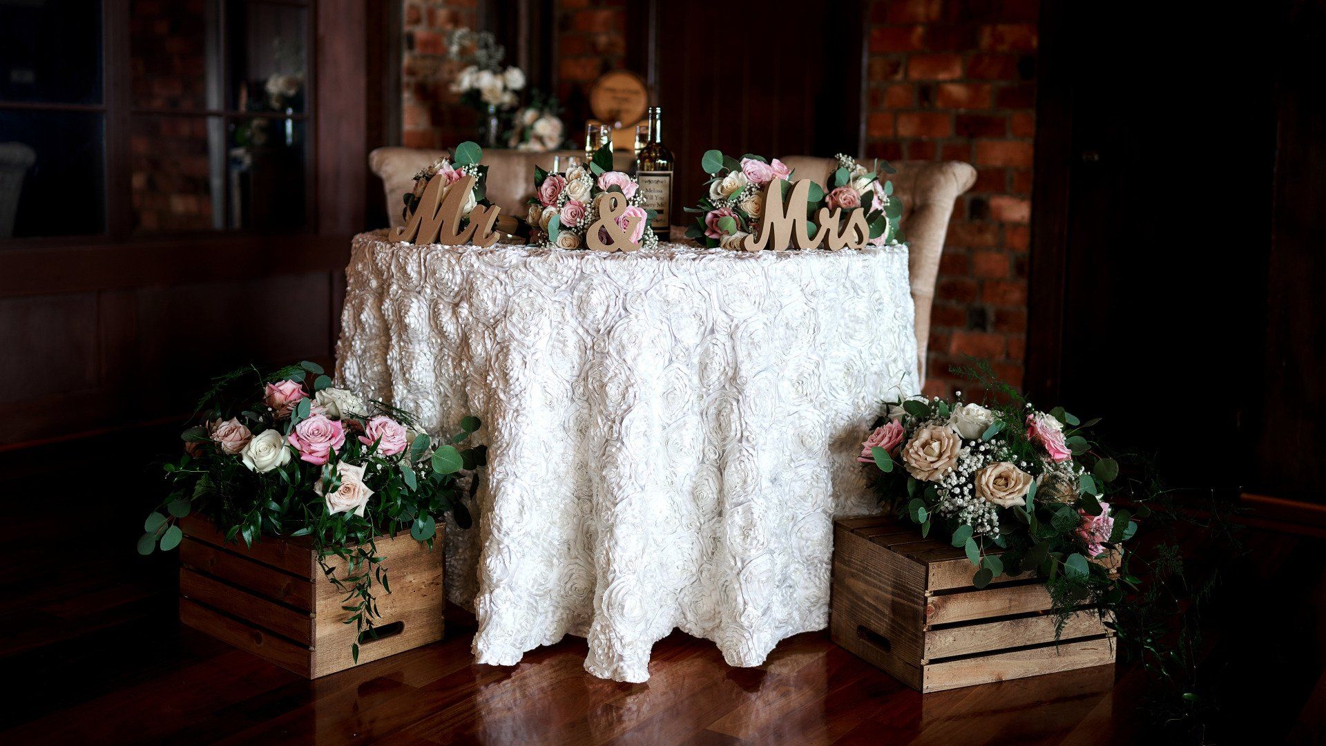 A table with a white tablecloth and flowers on it.