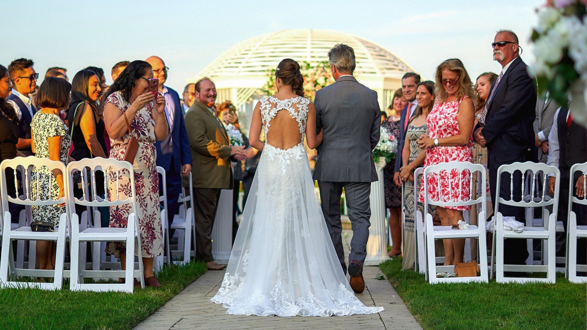 A bride and groom are walking down the aisle at their wedding.