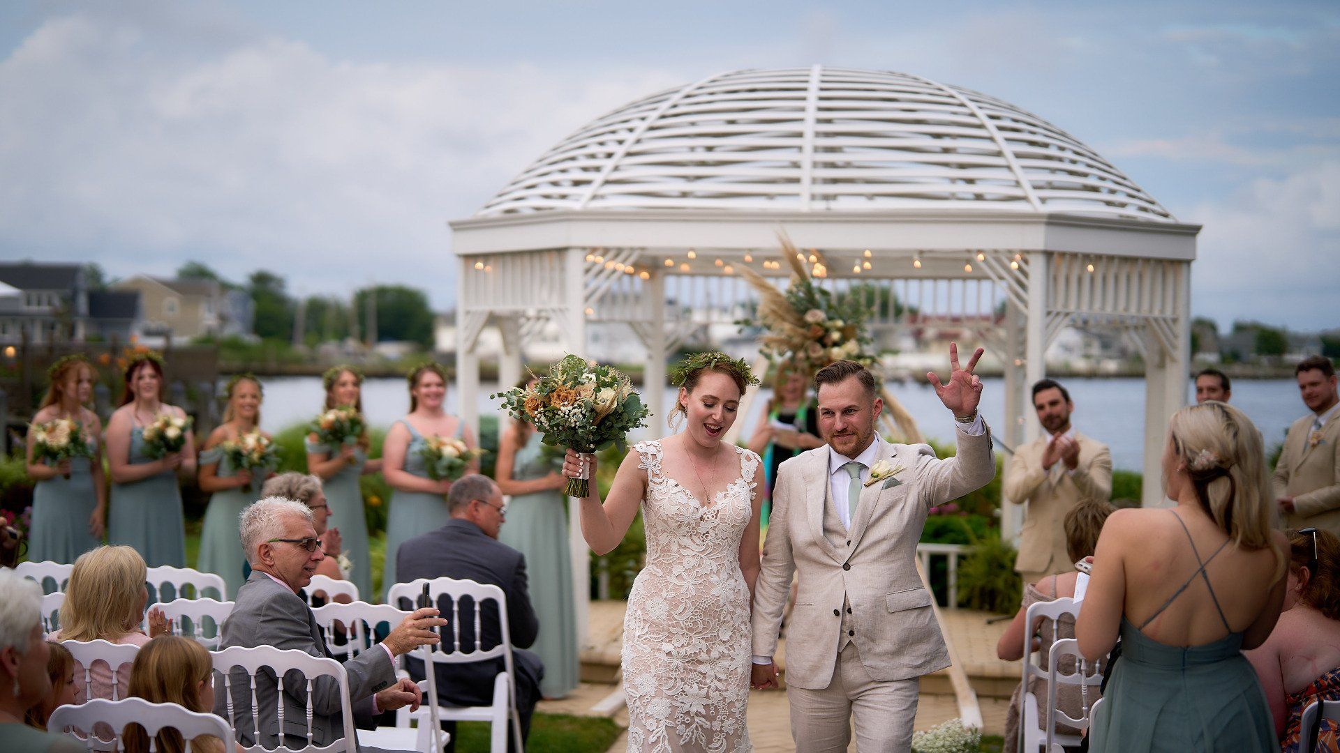 A bride and groom are walking down the aisle at their wedding.