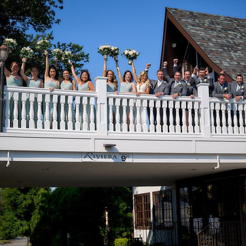 A group of people standing on a bridge that says riviera on it