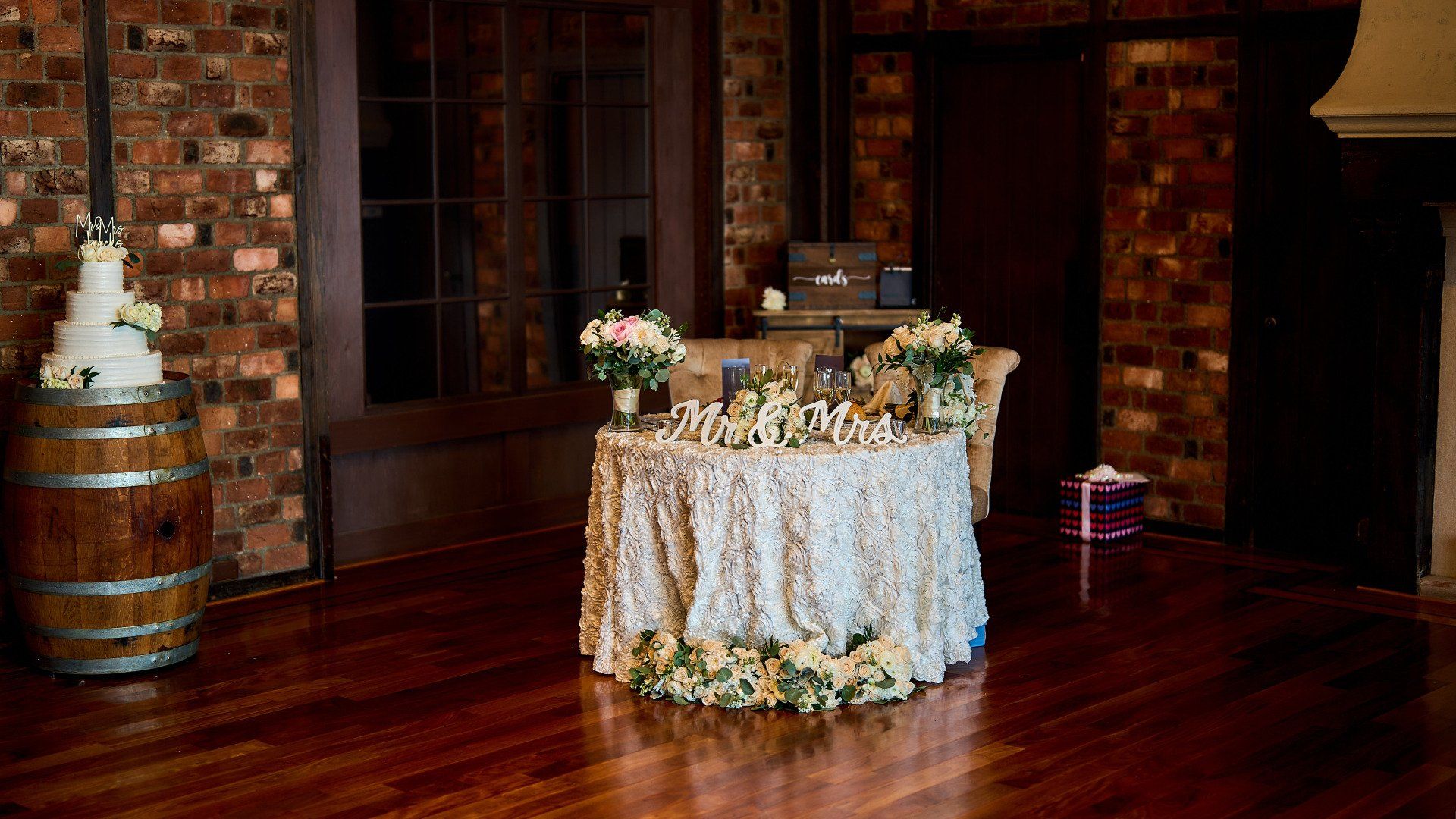 A wedding cake is sitting on top of a table in a room.