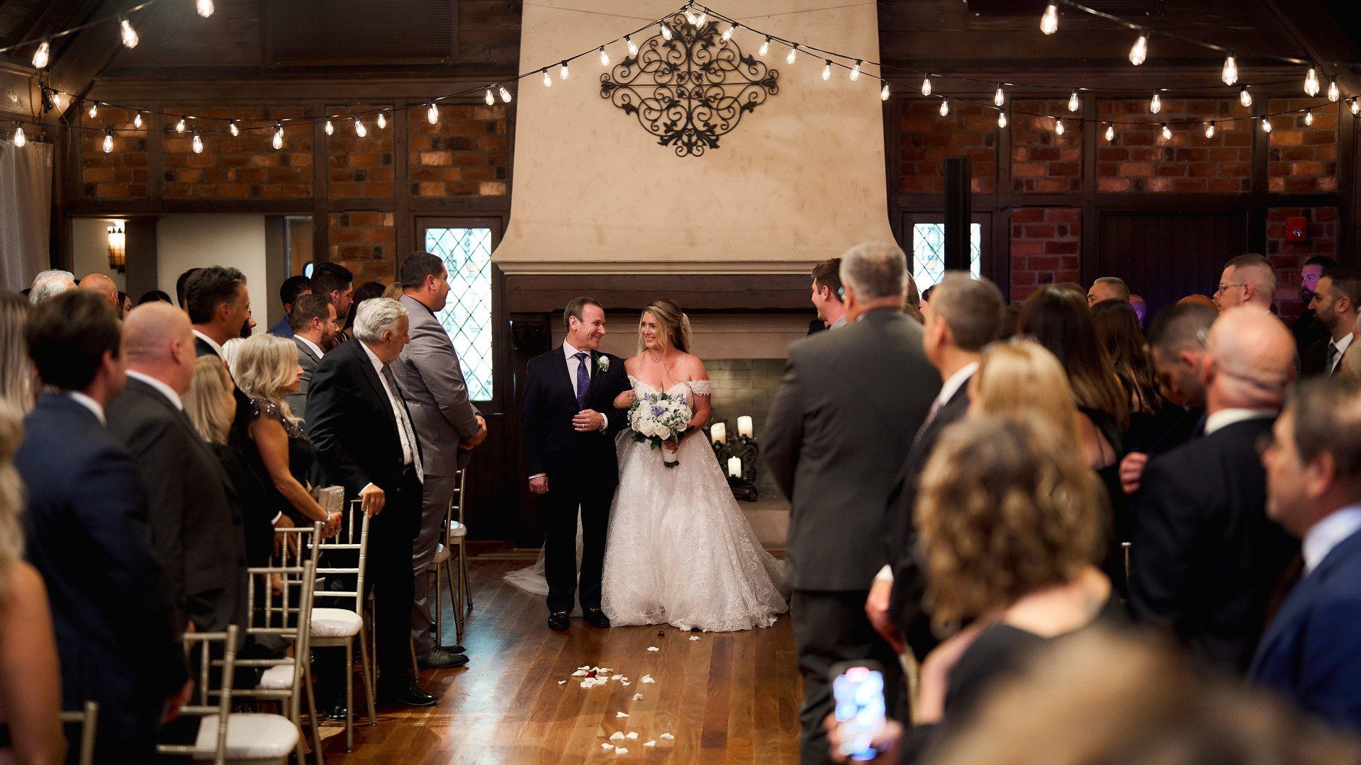 A bride and groom are walking down the aisle at their wedding ceremony.