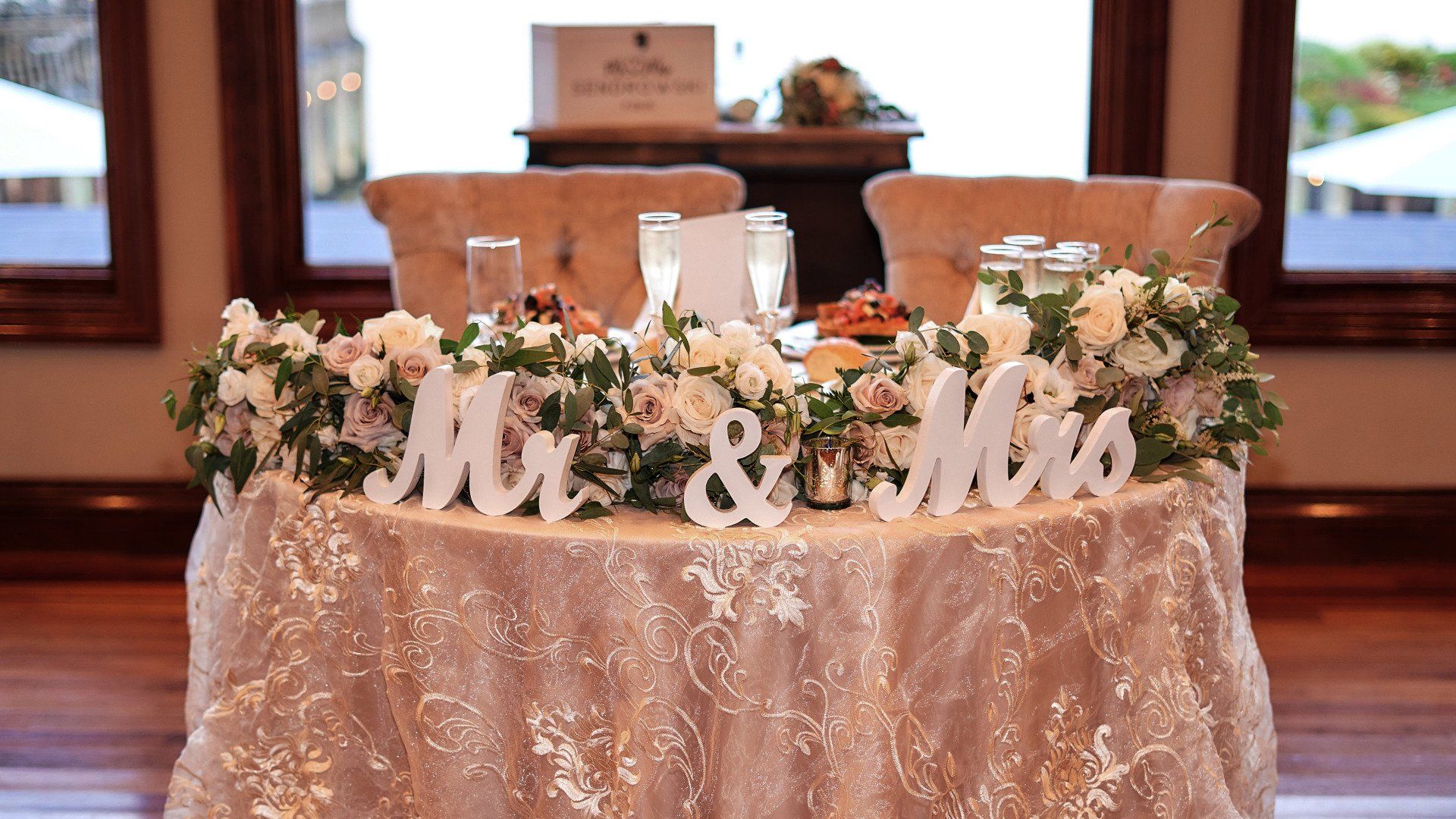 A table with flowers and a sign that says mr. and mrs.