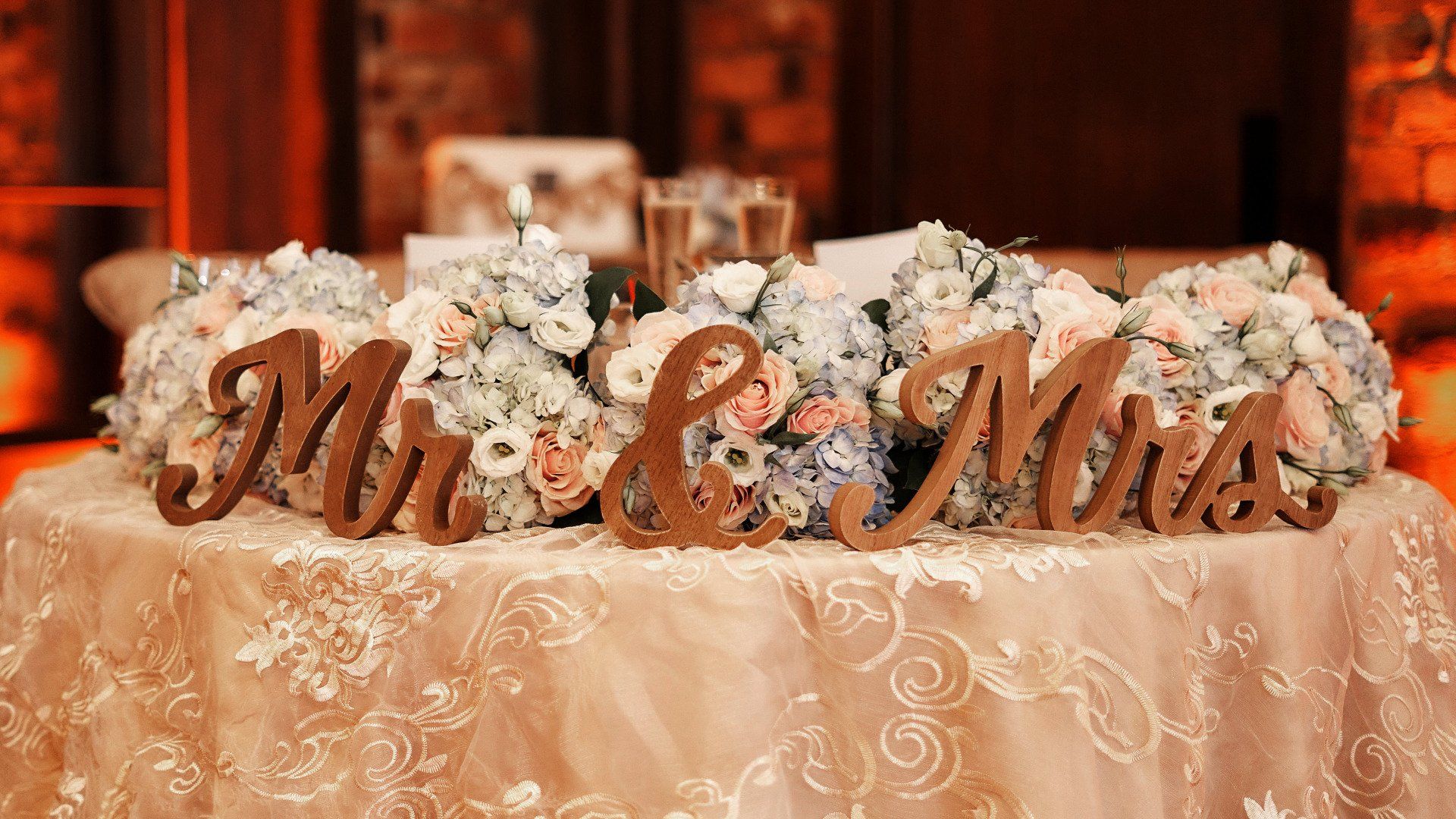 A table with flowers and wooden signs that say mr. and mrs. on it.