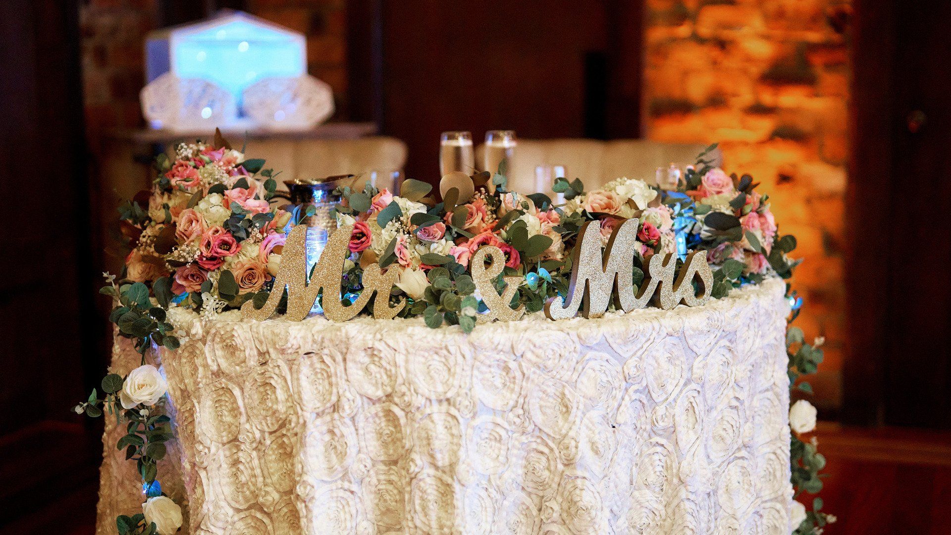 A table with flowers and a sign that says mr. and mrs. on it.