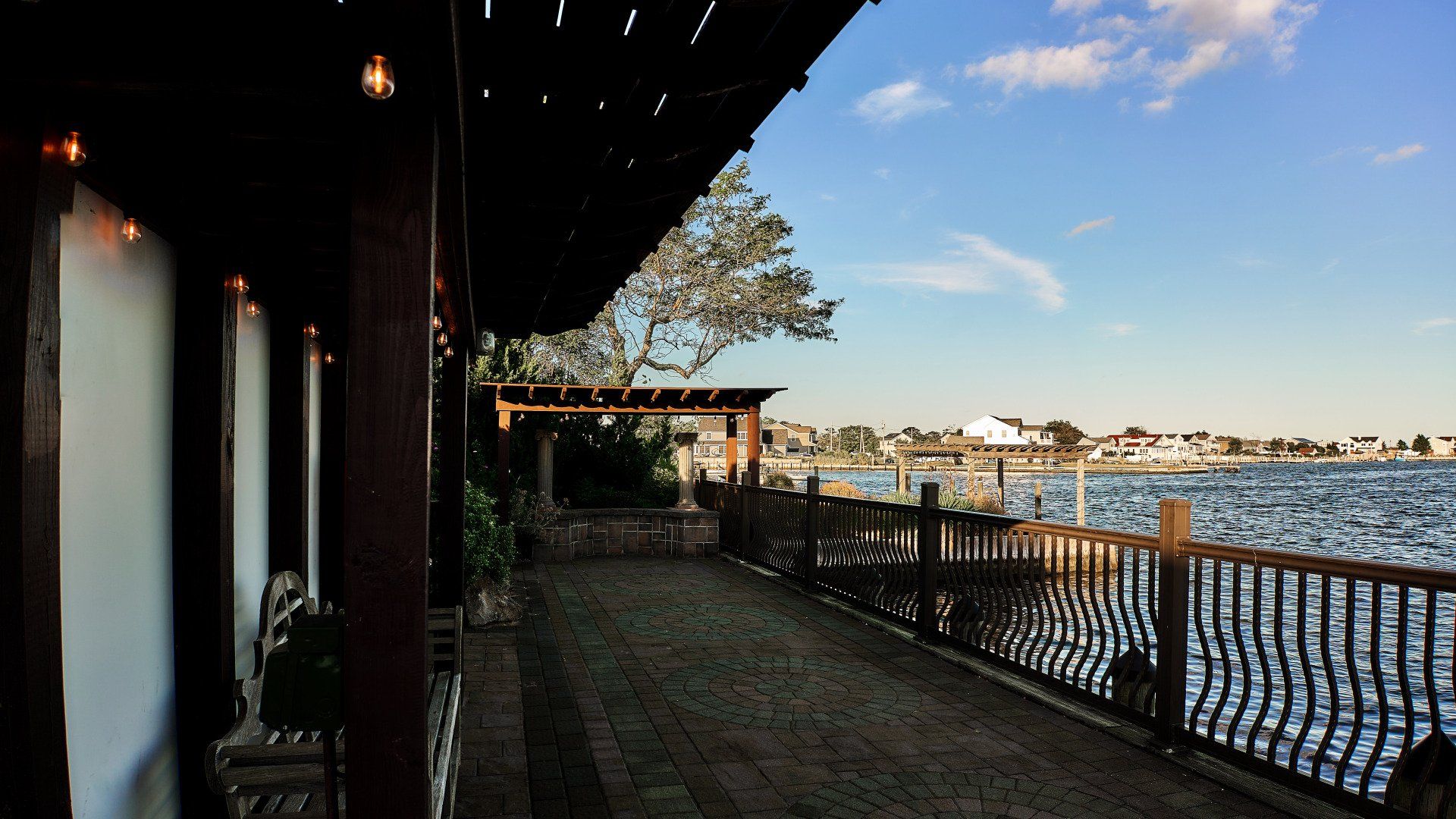 A patio with a view of a body of water