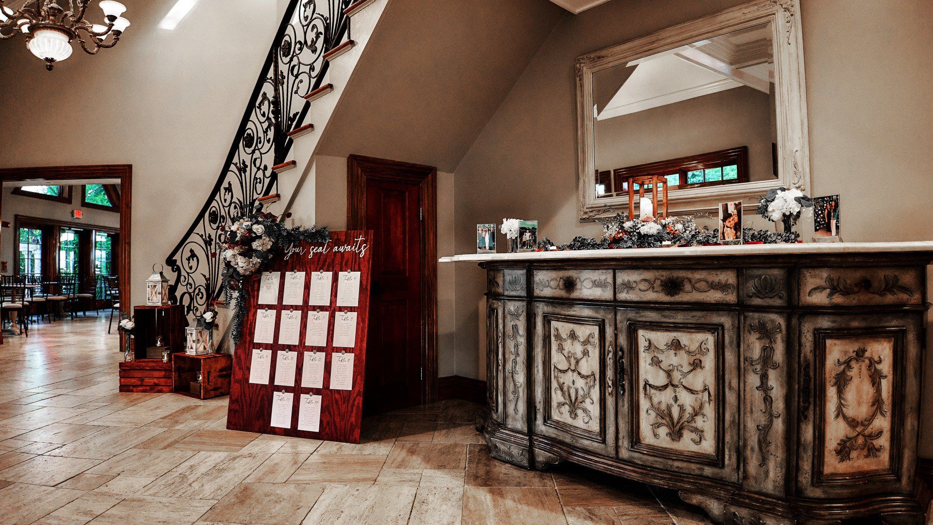 A large room with a staircase and a dresser