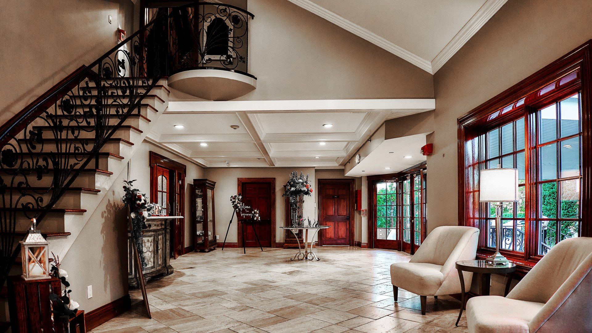 A large room with a staircase and chairs in it