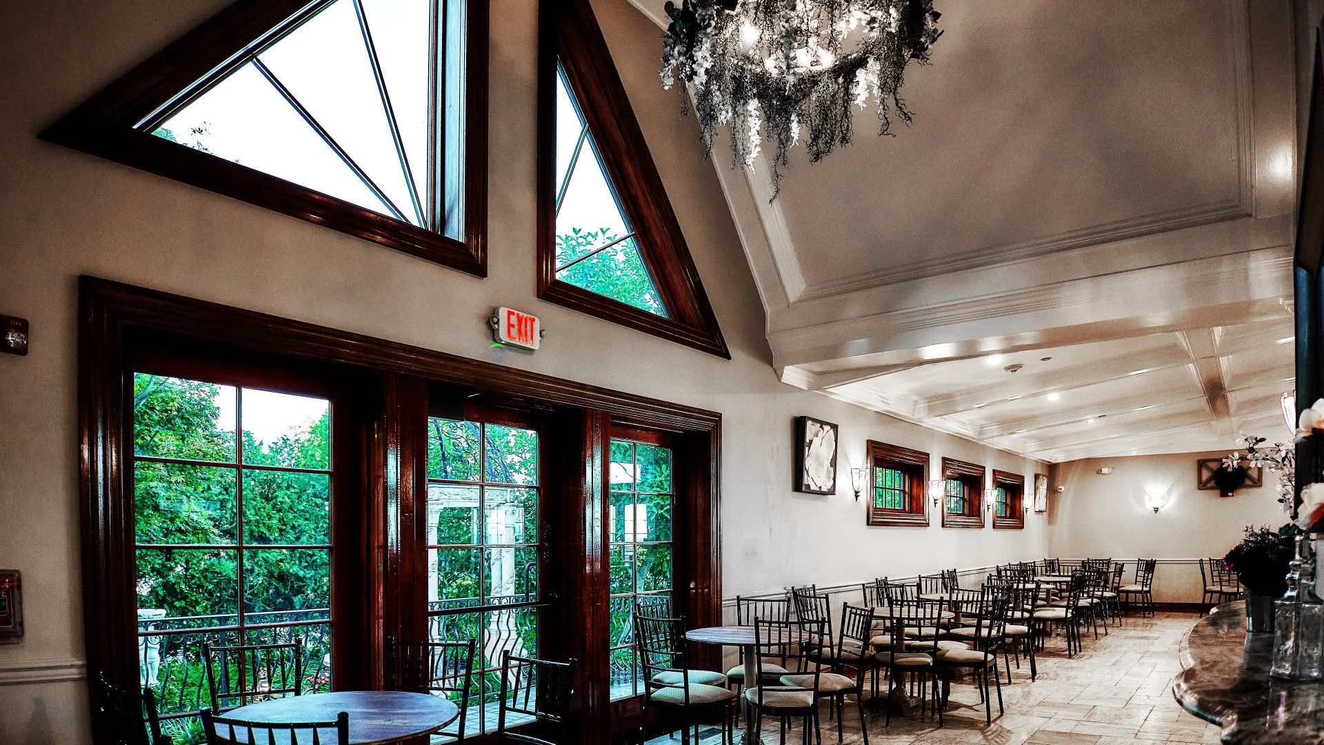 A large room with tables and chairs and a chandelier
