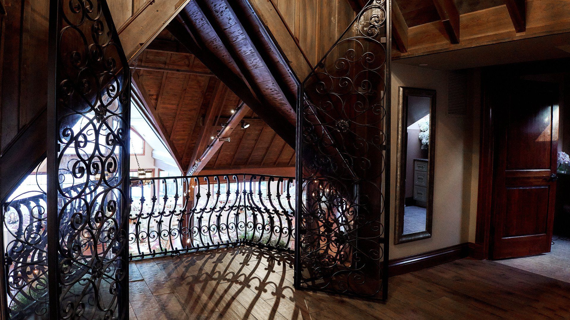 An empty room with a balcony and a mirror