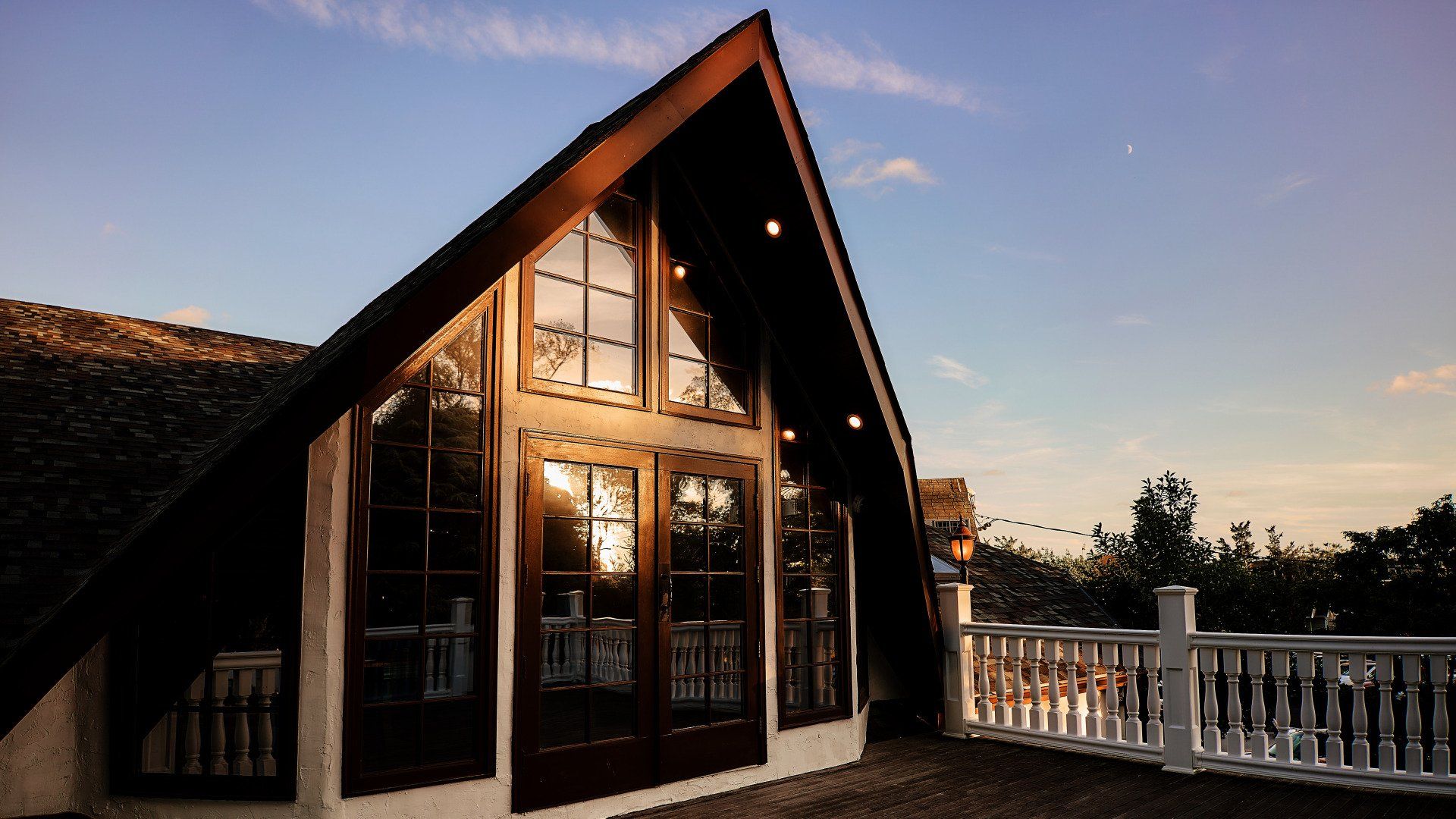 A large house with a thatched roof and lots of windows