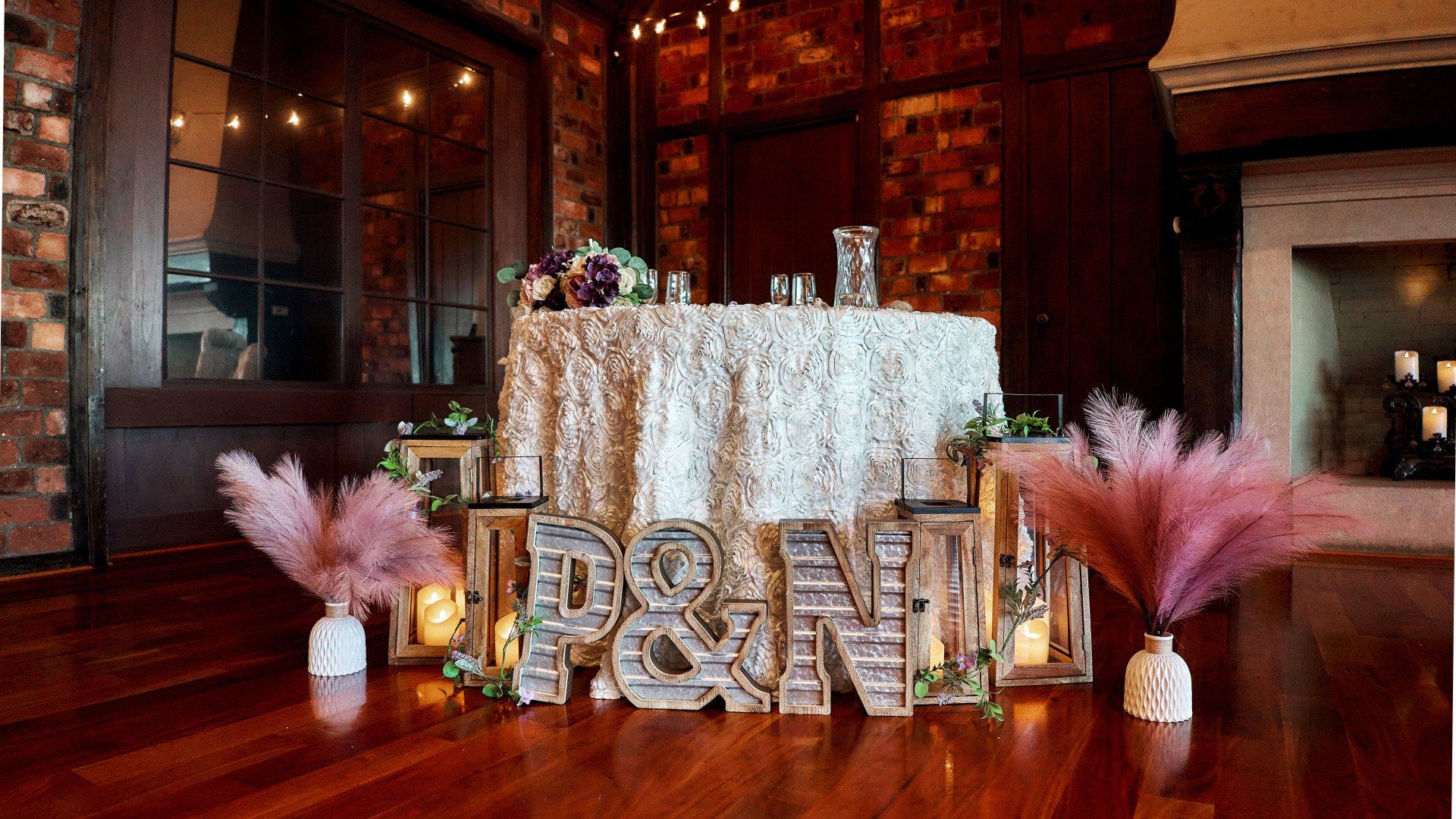 A table with a white table cloth and a sign that says p & n on it.