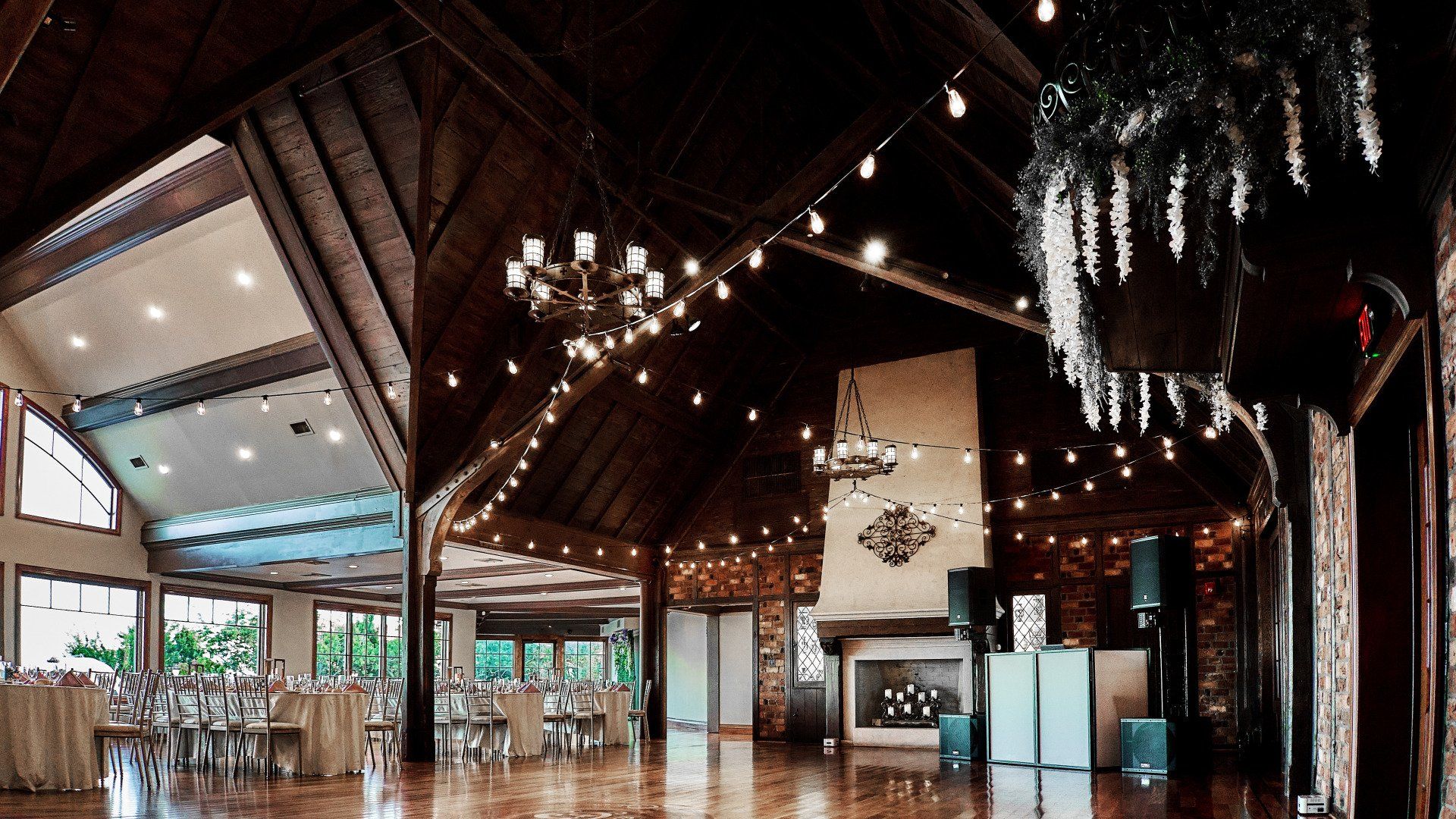 A large room with a fireplace and a chandelier hanging from the ceiling.