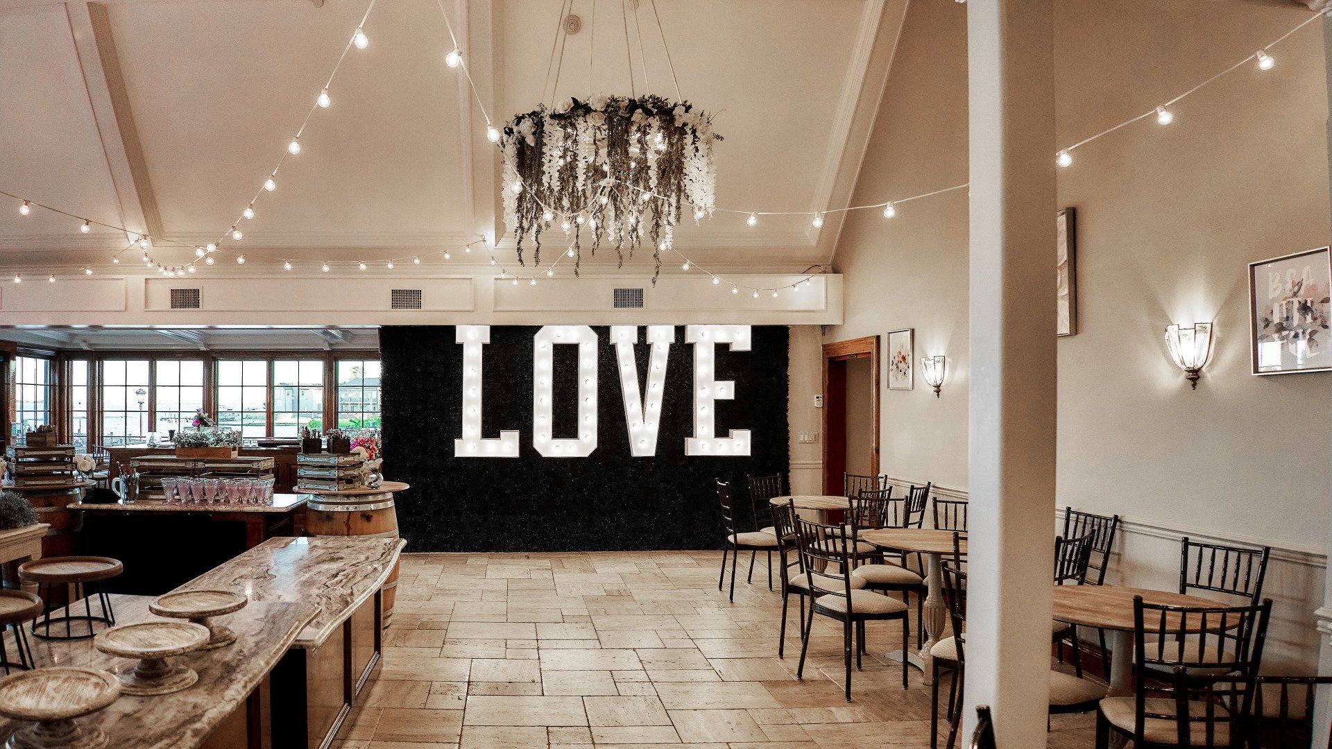 A large sign that says love is on the wall of a restaurant.