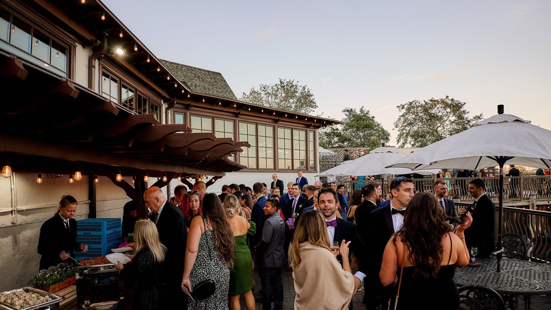 A large group of people are standing outside of a building.