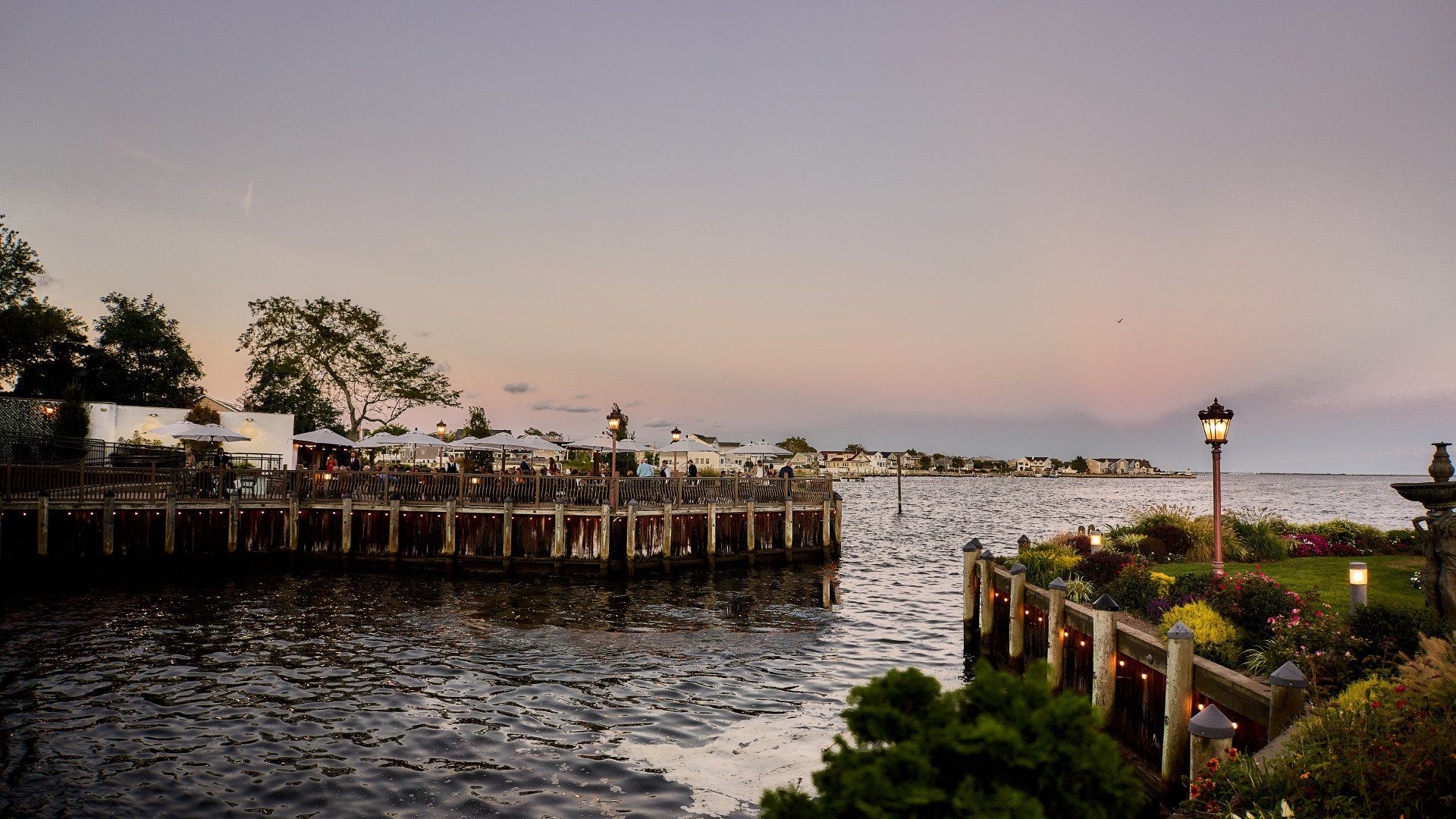 A dock overlooking a body of water with a sunset in the background