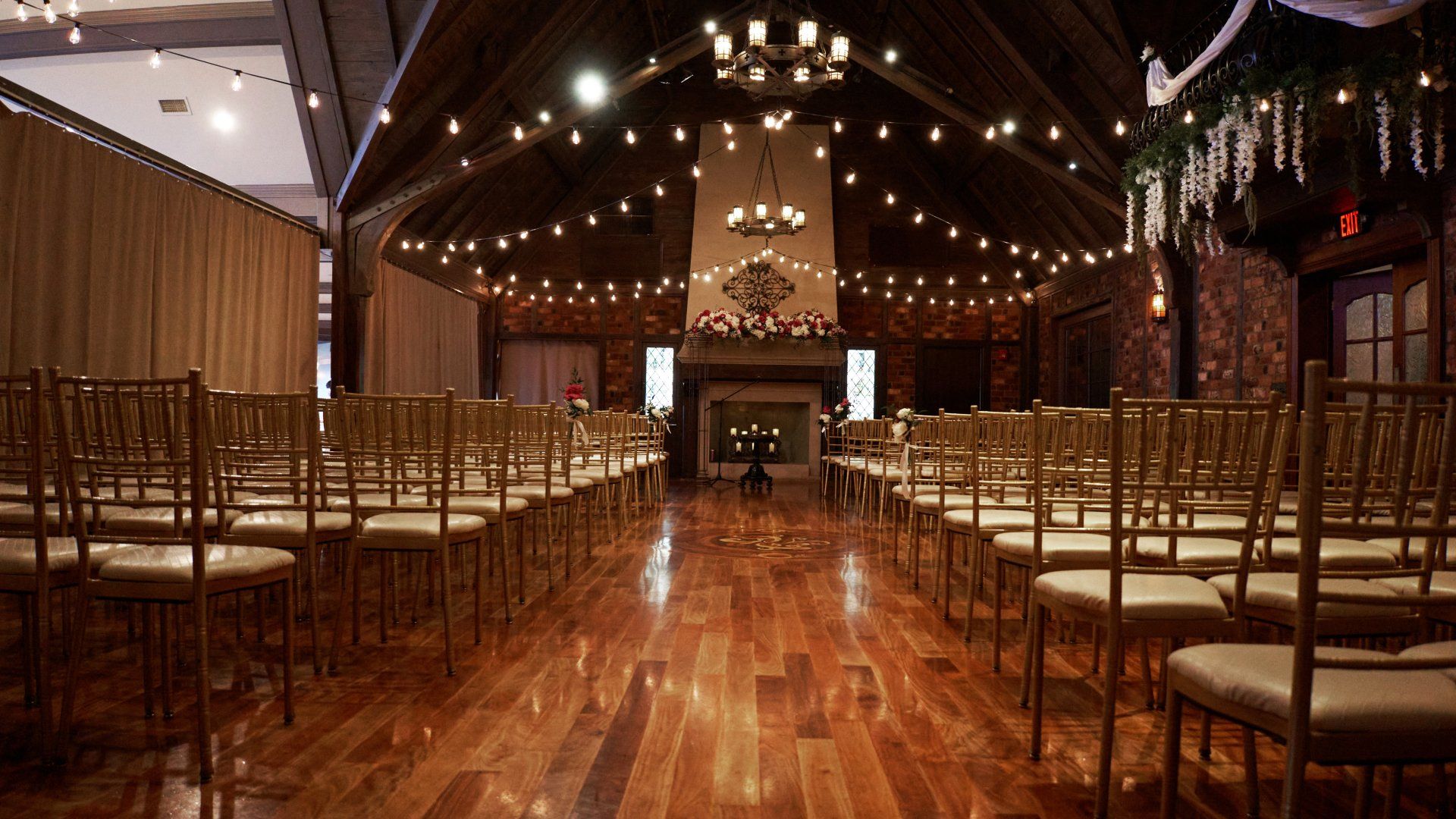 Rows of chairs are lined up in a large room for a wedding ceremony.