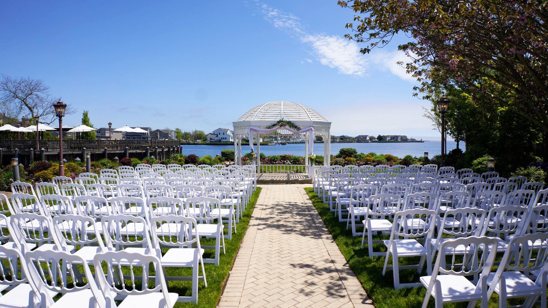 Rows of white chairs are lined up in front of a gazebo