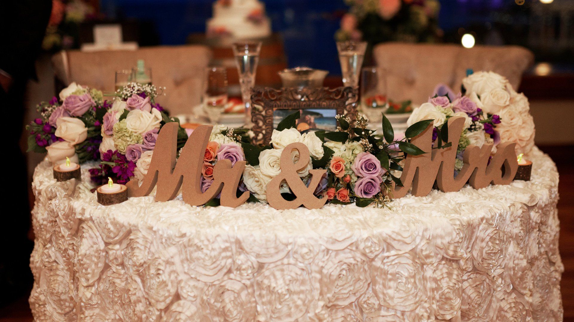 A table with flowers and wooden letters that say mr. and mrs.