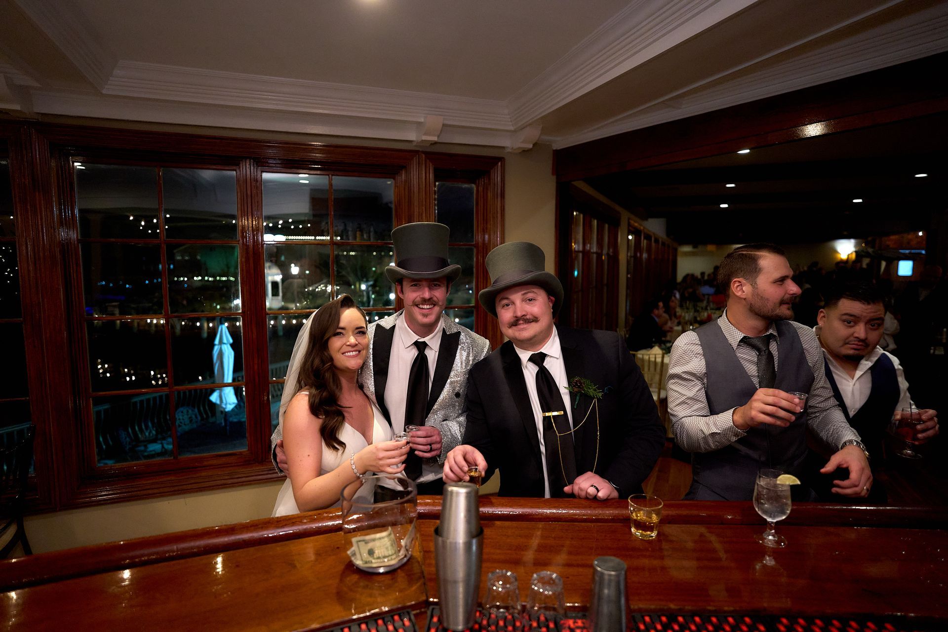 A group of people are posing for a picture at a bar.