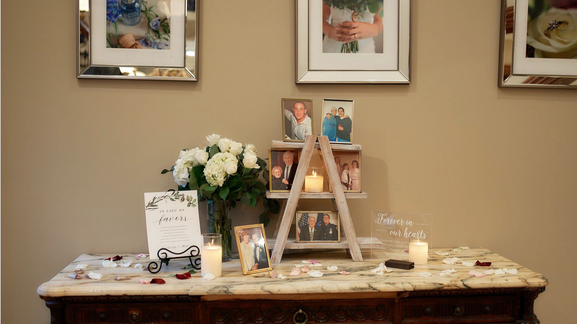 A table with pictures on it and candles on it.