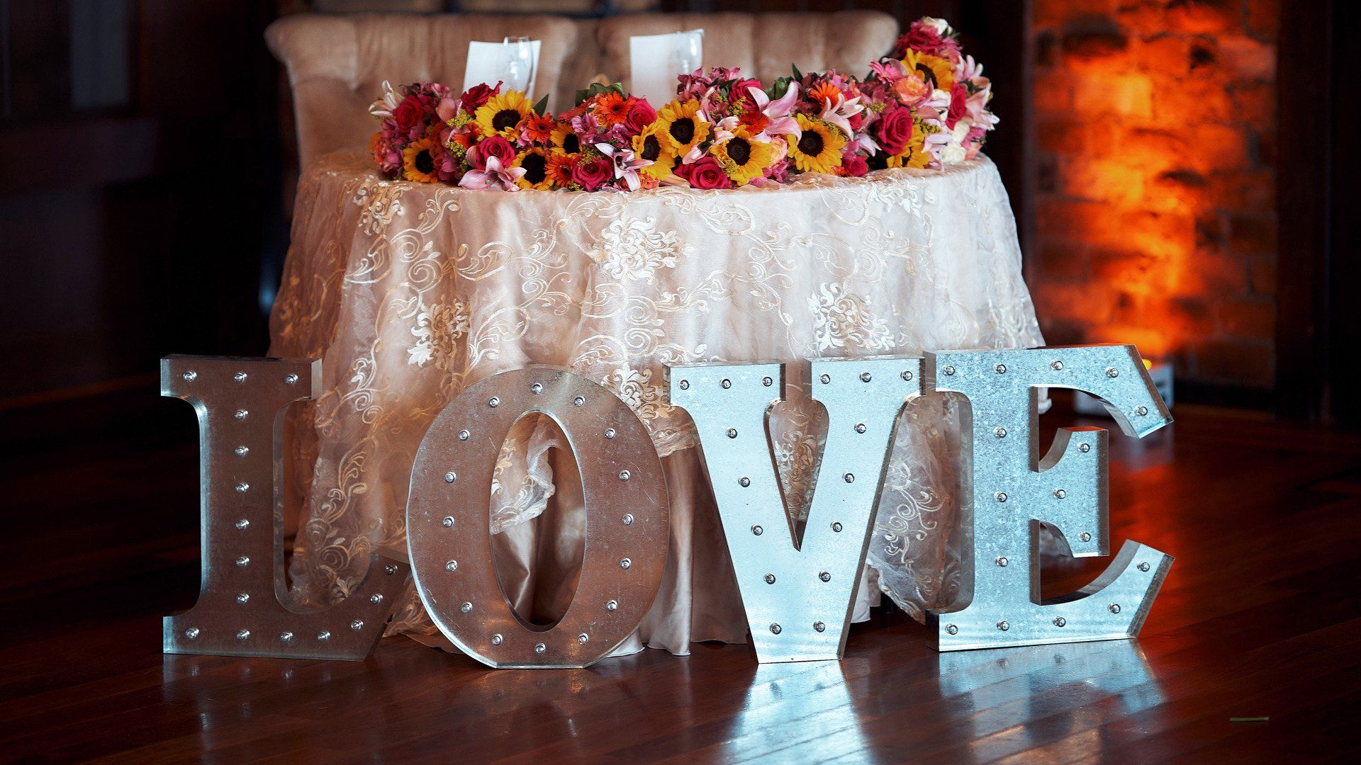 A table with flowers and a love sign on it.