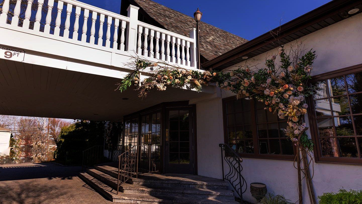 A white house with a balcony and stairs