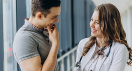 A doctor is talking to a patient in a hospital.