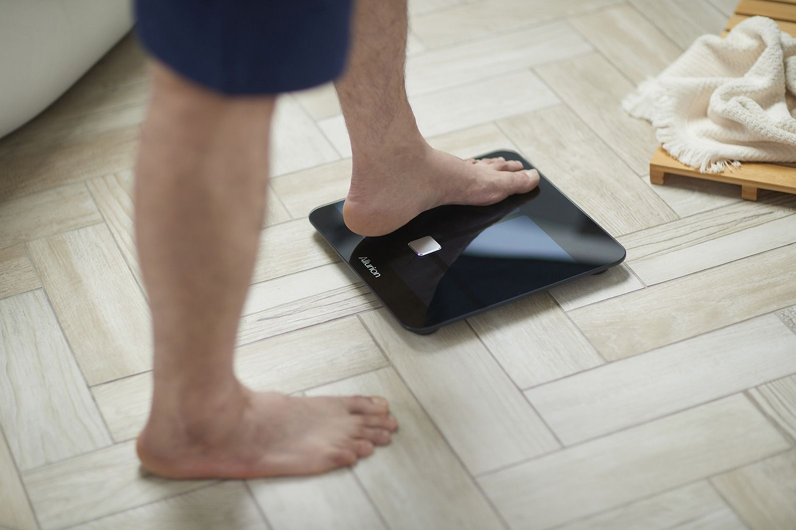 man standing on the bathroom scales