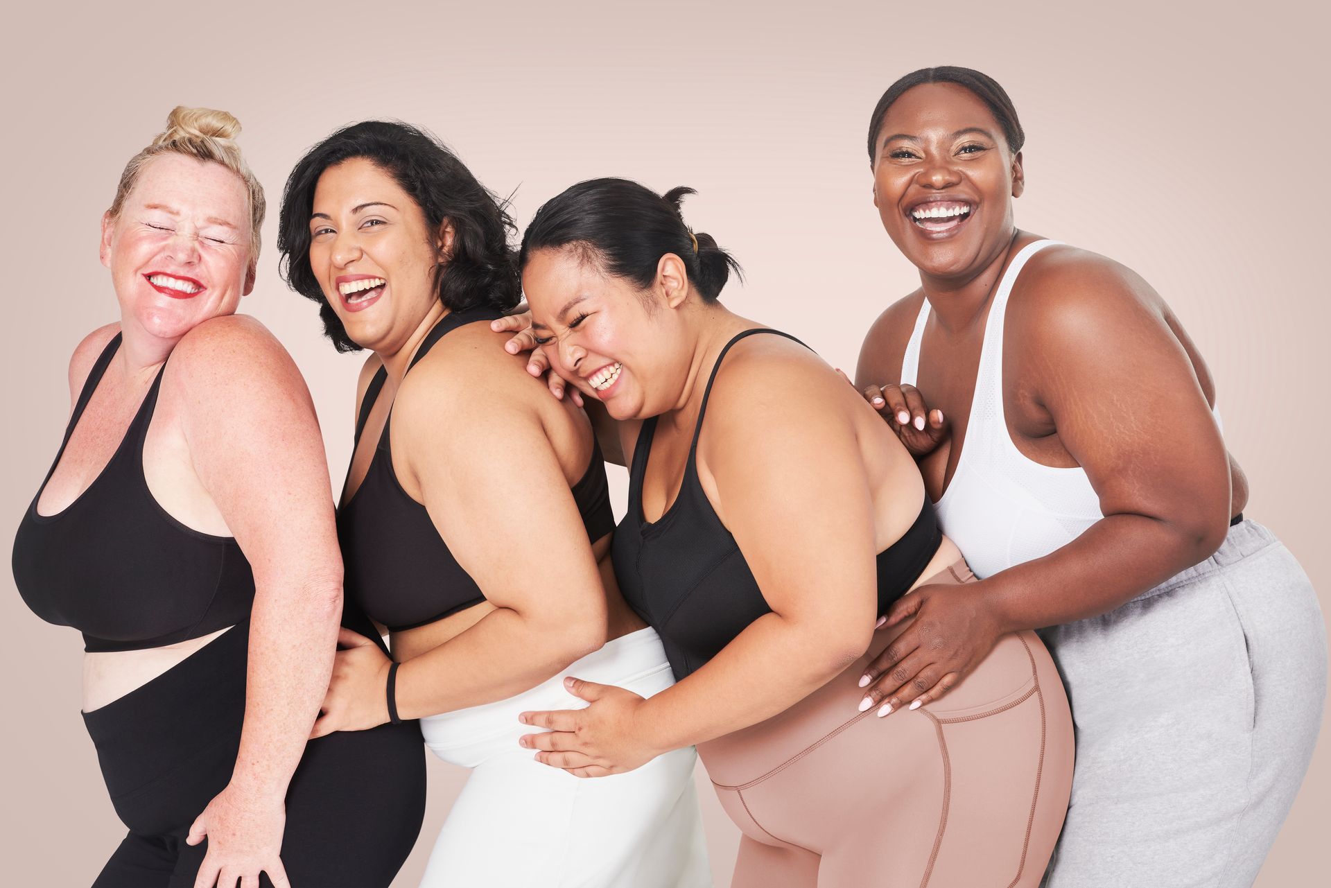 laughing women with excess weight in sportswear