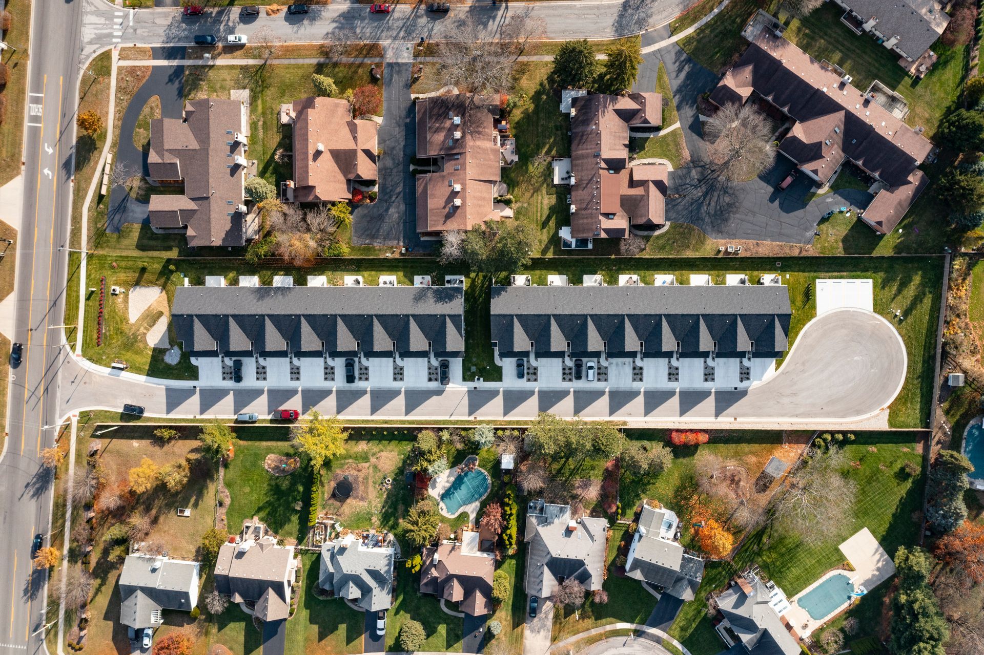 Photo of Olander Village seen from the sky - it's a row of houses on a street with a cul-de-sac