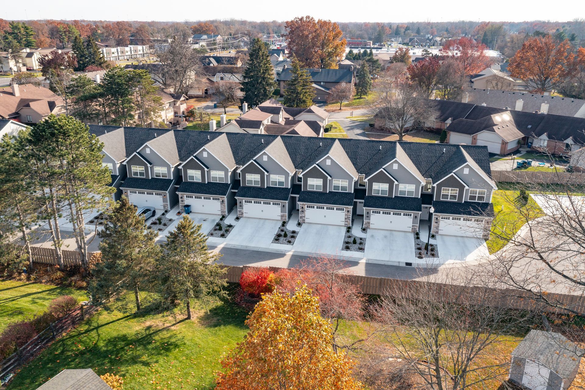 Photo of a single row of two-story houses on a street
