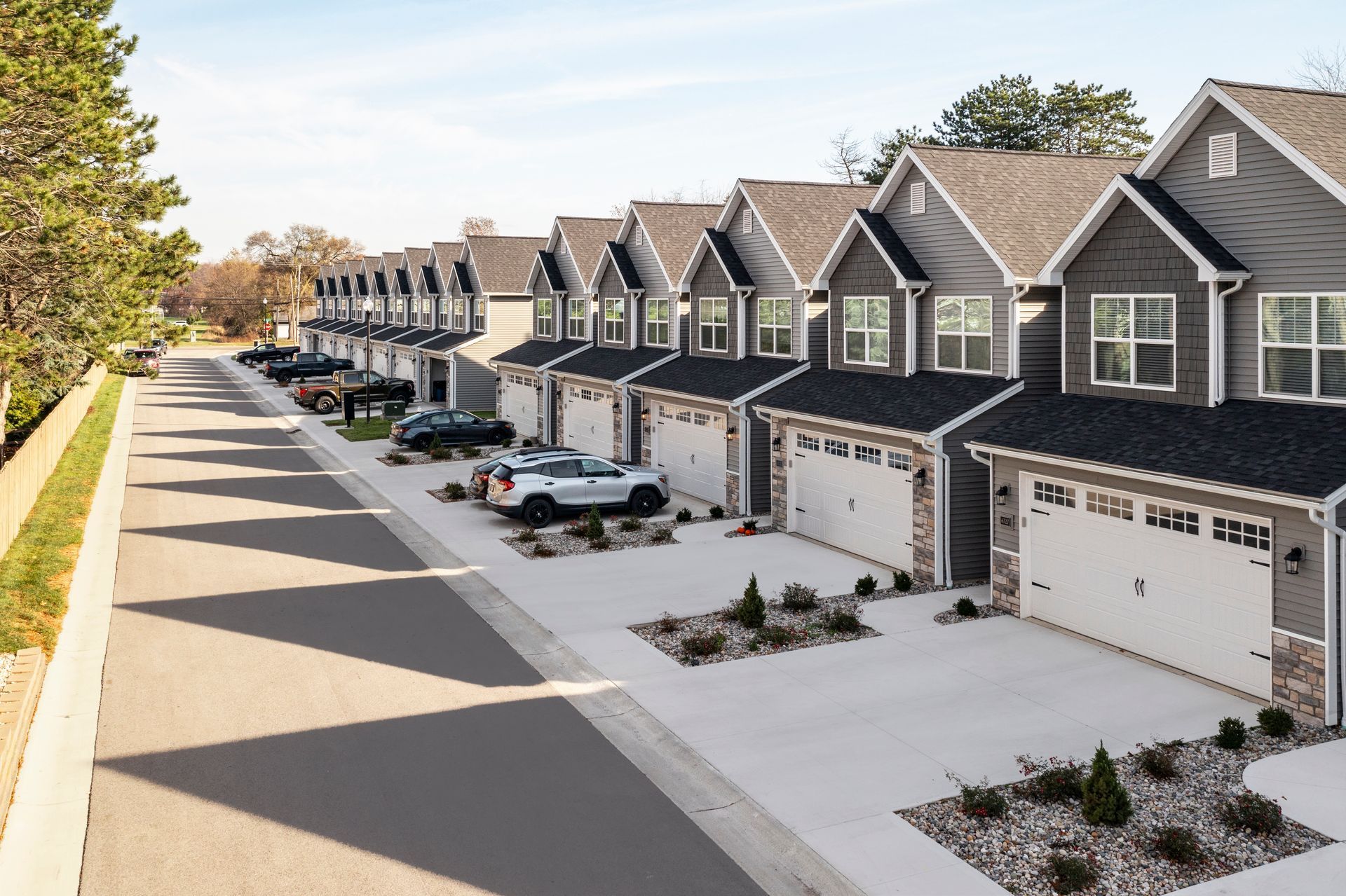 Photo of a row of houses showing driveways and garages