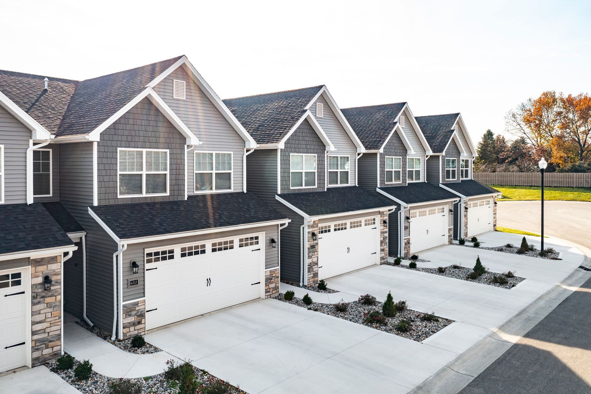 Photo of a few of the units, showing two-story homes and garages and driveways